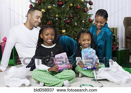 African sisters holding Christmas gifts View Large Photo Image Stock Photo - African sisters holding Christmas gifts. Fotosearch