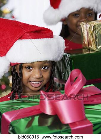 African sisters holding Christmas gifts View Large Photo Image Stock Photography - African sisters holding Christmas gifts. Fotosearch