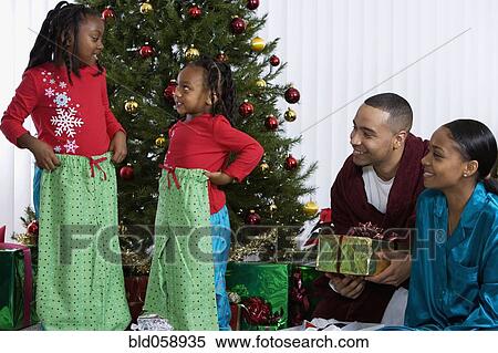 African sisters holding matching Christmas gifts View Large Photo Image Stock Photography - African sisters holding matching Christmas gifts. Fotosearch