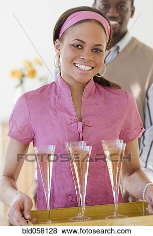 African woman carrying tray of champagne View Large Photo Image Stock Photo - African woman carrying tray of champagne. Fotosearch