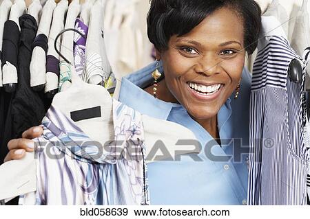 African woman clothes shopping View Large Photo Image Stock Photo - African woman clothes shopping. Fotosearch