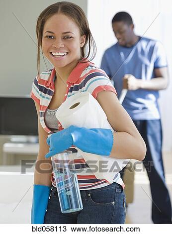 Stock Image - African woman holding paper towels. Fotosearch