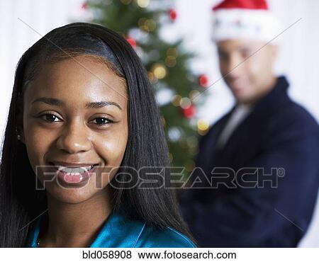 African woman in front of Christmas tree View Large Photo Image Stock Photo - African woman in front of Christmas tree. Fotosearch