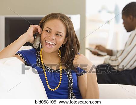 Stock Photography - African woman talking on telephone. Fotosearch