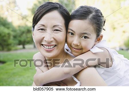 Asian bride and flower girl hugging View Large Photo Image Stock Photography - Asian bride and flower girl hugging. Fotosearch