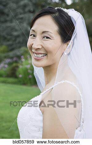 Asian bride looking over shoulder View Large Photo Image Stock Photo - Asian bride looking over shoulder. Fotosearch