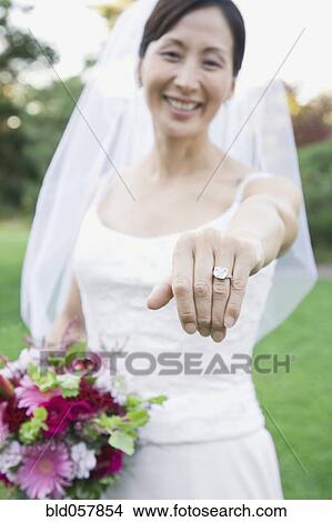 Asian bride showing wedding ring View Large Photo Image Picture - Asian bride showing wedding ring. Fotosearch