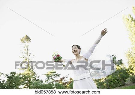 Asian bride with arms outstretched View Large Photo Image Stock Photo - Asian bride with arms outstretched. Fotosearch