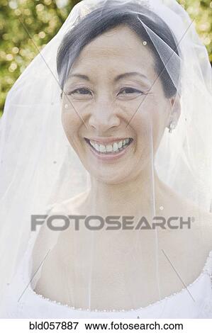 Stock Photo - Asian bride with veil covering face. Fotosearch