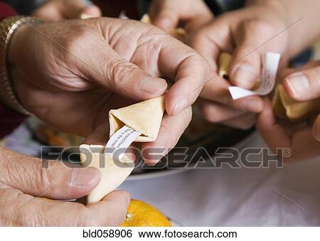 Asian family opening fortune cookies View Large Photo Image Stock Photograph - Asian family opening fortune cookies. Fotosearch