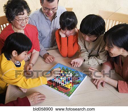 Asian family playing board game View Large Photo Image Stock Image - Asian family playing board game. Fotosearch