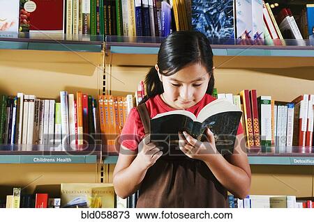 Stock Image - Asian girl reading in store. Fotosearch