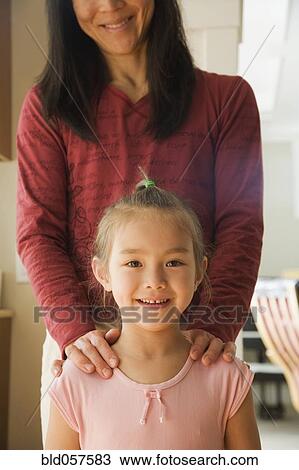 Asian mother with hands on daughter’s shoulders View Large Photo Image Stock Image - Asian mother with hands on daughter’s shoulders. Fotosearch