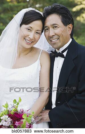 Asian newlyweds hugging View Large Photo Image Stock Image - Asian newlyweds hugging. Fotosearch