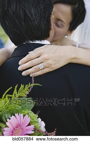 Asian newlyweds kissing View Large Photo Image Picture - Asian newlyweds kissing. Fotosearch