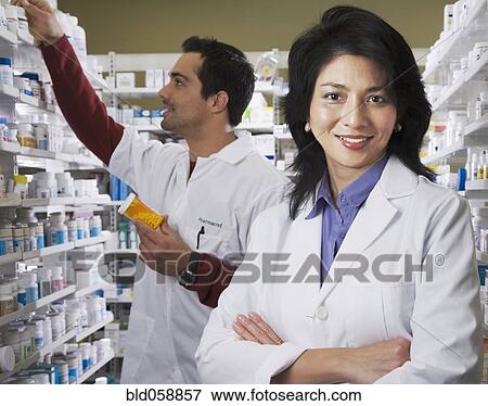 Asian pharmacist in front of coworker View Large Photo Image Stock Photo - Asian pharmacist in front of coworker. Fotosearch