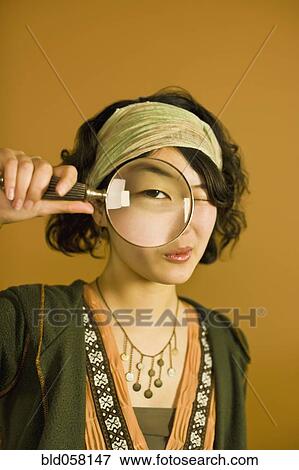 Asian woman looking through magnifying glass View Large Photo Image Stock Photo - Asian woman looking through magnifying glass. Fotosearch