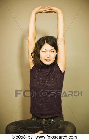Stock Photo - Asian woman stretching. Fotosearch