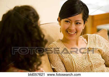 Asian woman talking to friend View Large Photo Image Stock Image - Asian woman talking to friend. Fotosearch