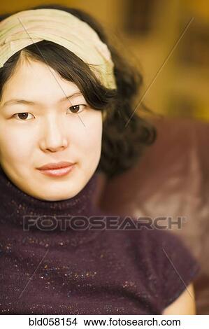 Picture - Asian woman wearing headband. Fotosearch