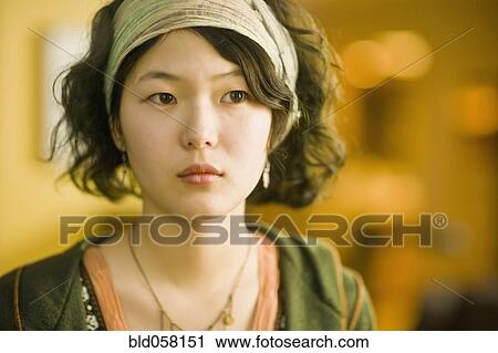 Stock Image - Asian woman wearing headband. Fotosearch
