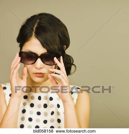 Stock Photo - Asian woman wearing sunglasses. Fotosearch