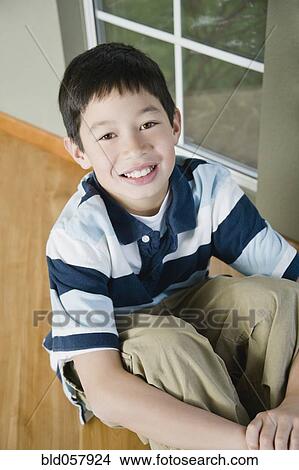 Picture - Close up of Mixed Race boy smiling. Fotosearch