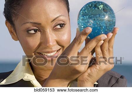 Hispanic businesswoman holding glass orb View Large Photo Image Stock Image - Hispanic businesswoman holding glass orb. Fotosearch
