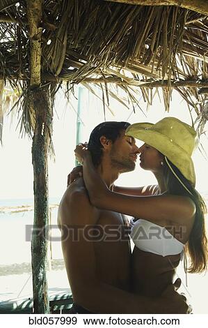 Stock Photo - Hispanic couple about to kiss. Fotosearch