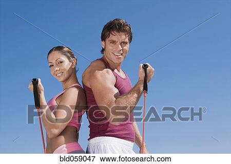 Hispanic couple exercising with exercise bands View Large Photo Image Stock Photo - Hispanic couple exercising with exercise bands. Fotosearch