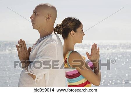Picture - Hispanic couple practicing yoga. Fotosearch