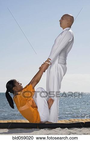 Hispanic couple practicing yoga View Large Photo Image Stock Image - Hispanic couple practicing yoga. Fotosearch