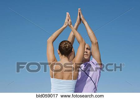 Hispanic couple practicing yoga View Large Photo Image Stock Photo - Hispanic couple practicing yoga. Fotosearch