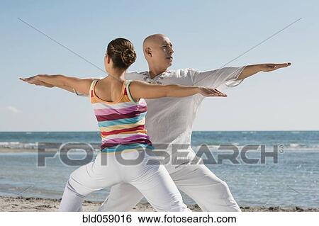 Hispanic couple practicing yoga View Large Photo Image Stock Photograph - Hispanic couple practicing yoga. Fotosearch