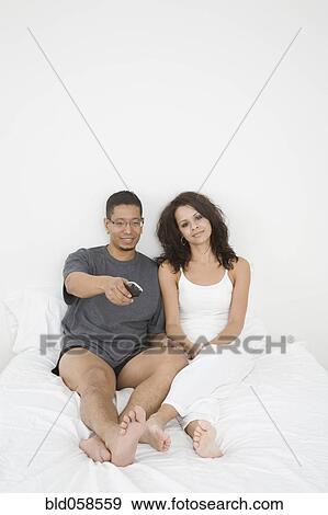 Hispanic couple watching television View Large Photo Image Stock Photo - Hispanic couple watching television. Fotosearch
