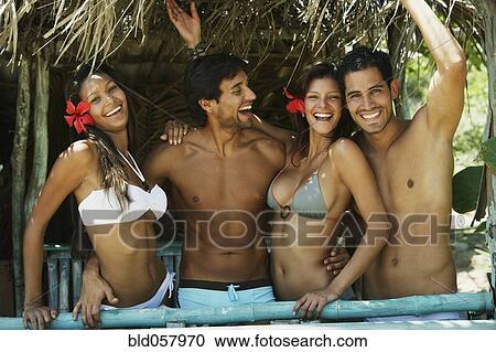 Hispanic couples in beach hut View Large Photo Image Stock Image - Hispanic couples in beach hut. Fotosearch
