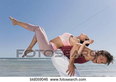 Hispanic man balancing woman on back View Large Photo Image Stock Photograph - Hispanic man balancing woman on back. Fotosearch