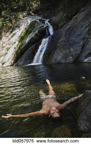 Hispanic man floating in water View Large Photo Image Stock Photography - Hispanic man floating in water. Fotosearch