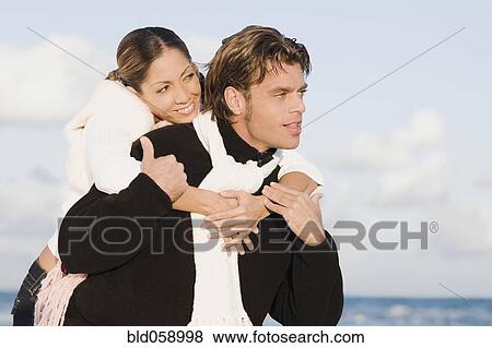 Hispanic man giving girlfriend piggy back ride View Large Photo Image Stock Photo - Hispanic man giving girlfriend piggy back ride. Fotosearch