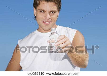 Hispanic man holding water bottle View Large Photo Image Stock Image - Hispanic man holding water bottle. Fotosearch