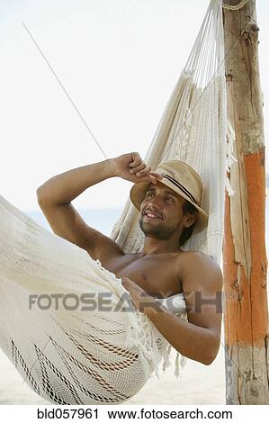 Hispanic man laying in hammock View Large Photo Image Stock Image - Hispanic man laying in hammock. Fotosearch