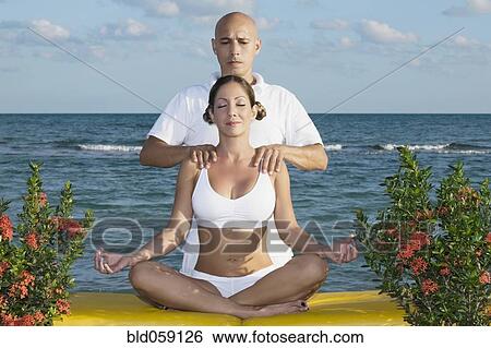 Hispanic man massaging meditating woman View Large Photo Image Stock Photograph - Hispanic man massaging meditating woman. Fotosearch