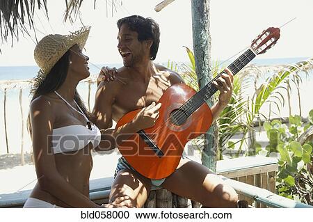 Hispanic man playing guitar for girlfriend View Large Photo Image Stock Image - Hispanic man playing guitar for girlfriend. Fotosearch