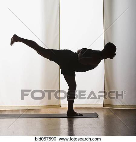 Stock Image - Hispanic man practicing yoga. Fotosearch