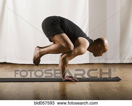 Stock Image - Hispanic man practicing yoga. Fotosearch