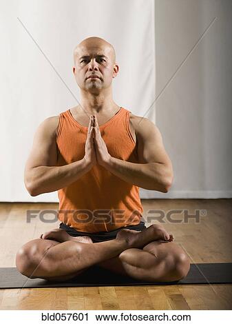 Stock Image - Hispanic man practicing yoga. Fotosearch