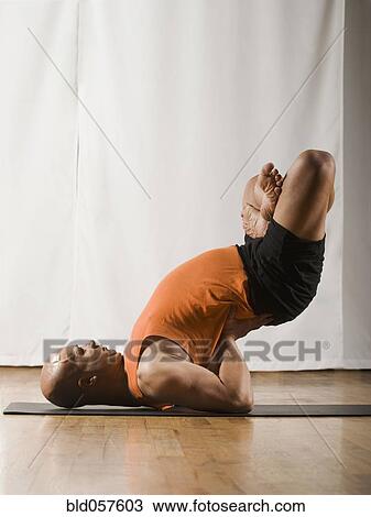Hispanic man practicing yoga View Large Photo Image Stock Image - Hispanic man practicing yoga. Fotosearch