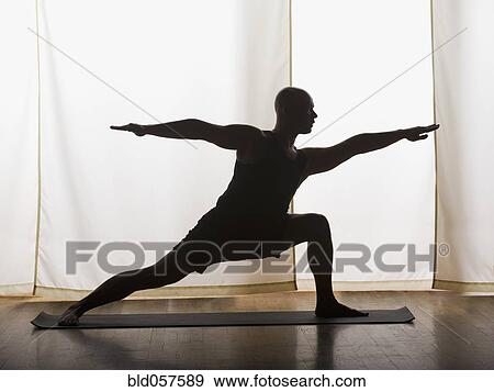 Stock Photo - Hispanic man practicing yoga. Fotosearch