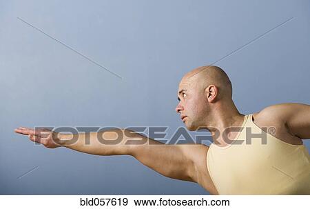 Stock Photo - Hispanic man practicing yoga. Fotosearch