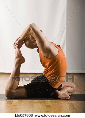 Stock Photograph - Hispanic man practicing yoga. Fotosearch